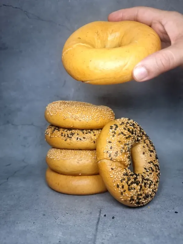 Stack of handmade Moi Doughssier sesame bagels — plain, sesame and black sesame varieties